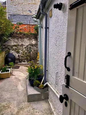 an entrance to a house with a door and some plants at St Ives fisherman cottage, Sleeps 5, pet friendly in St Ives