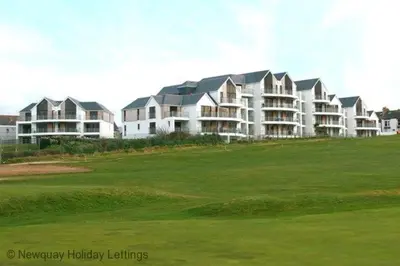 a group of large houses on a golf course at Headland View at Bredon Court in Newquay