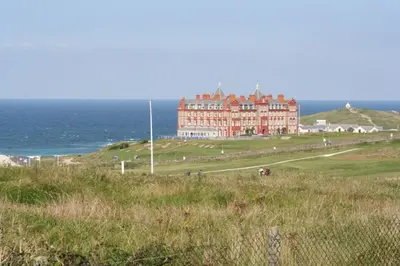 a large building on a hill next to the ocean at Headland View at Bredon Court in Newquay