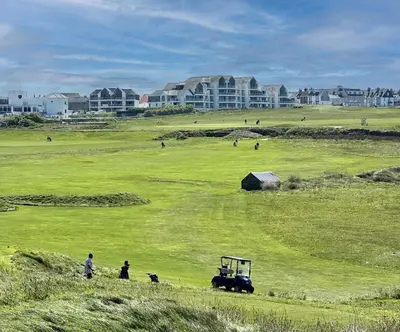 a group of people and a tractor in a field at Surf's Up! in Newquay