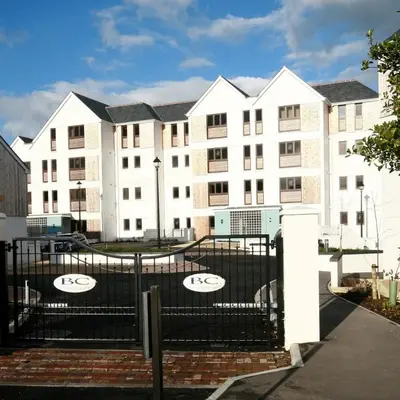 a building with a fence in front of it at Surf's Up! in Newquay