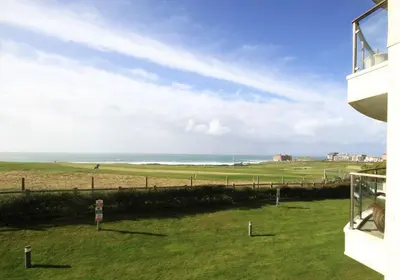 a view of the ocean from the balcony of a house at Surf's Up! in Newquay