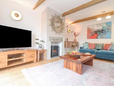 a living room with a flat screen tv and a couch at Riviere Barton in Hayle