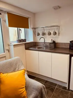 a kitchen with a sink and a counter top at Sea Whispers at Porthleven in Porthleven