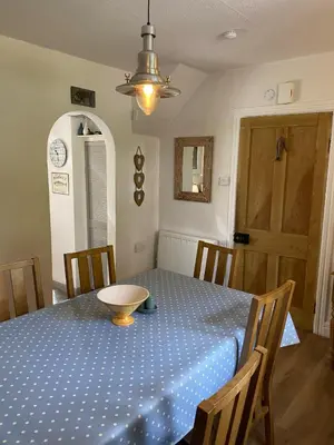 a dining room table with a blue polka dot table cloth at Hollyhocks in Saint Minver
