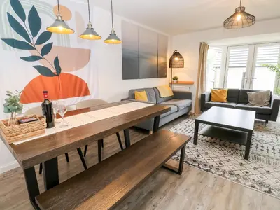 a living room with a table and a couch at 20 Bishops Way in Falmouth