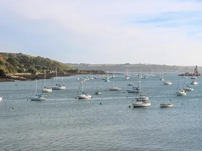a large group of boats sitting in the water at 20 Bishops Way in Falmouth