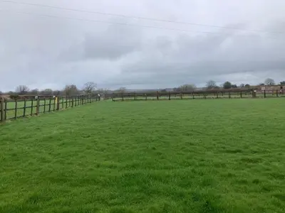 a large field with a fence and green grass at Little Haven in Launceston