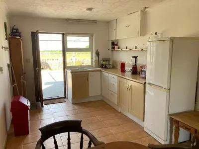 a kitchen with a white refrigerator and a table at Little Haven in Launceston