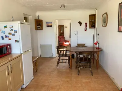 a kitchen with a table and a refrigerator at Little Haven in Launceston