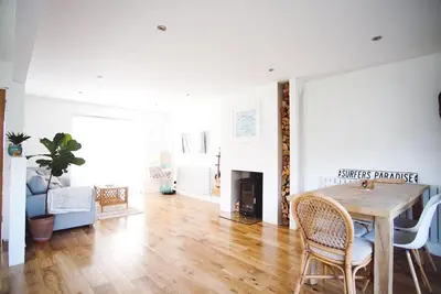 a living room with a wooden table and chairs at Family Home with Sauna & Garden in Newquay