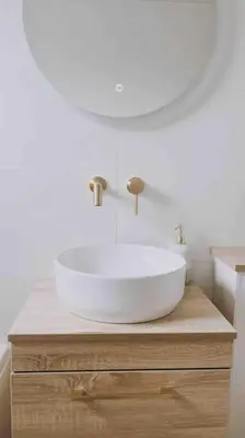a bathroom with a white sink on a wooden counter at Family Home with Sauna & Garden in Newquay