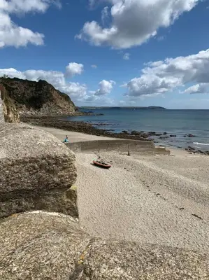 a boat on a rocky beach near the ocean at Charlestown Cottage Harbour & Beach short walk! in Charlestown