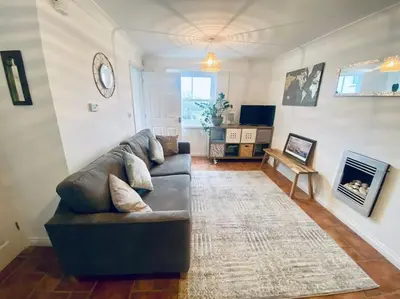 a living room with a couch and a fireplace at Charlestown Cottage Harbour & Beach short walk! in Charlestown