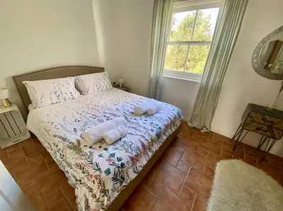 a bedroom with a bed with two towels on it at Charlestown Cottage Harbour & Beach short walk! in Charlestown