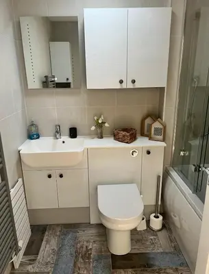 a bathroom with a toilet and a sink at Captains Quarters in Charlestown