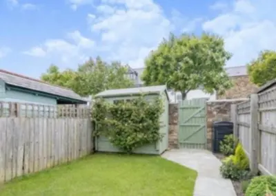 a backyard with a fence and a gate at Captains Quarters in Charlestown