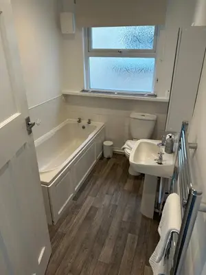 a bathroom with a tub and a toilet and a sink at Porth View Newquay in Saint Columb Minor