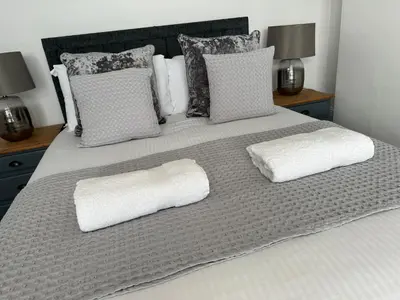 a bed with two white pillows on it at Porth View Newquay in Saint Columb Minor