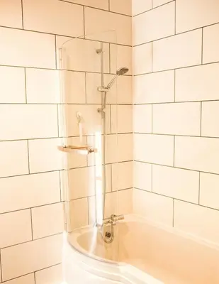 a bathroom with a shower and a bath tub at Glynn Bull Pen in Bodmin