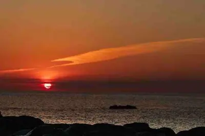 a sunset over the ocean with the sun setting at Secluded Luxury Pod with Hot Tub in Launceston