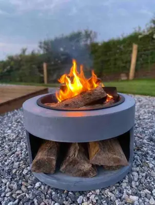 a fire pit sitting on a pile of rocks at Secluded Luxury Pod with Hot Tub in Launceston