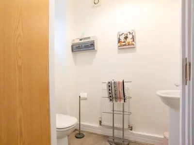 a bathroom with a toilet and a sink at Holiday Home Marshmallow House by Interhome in St Austell
