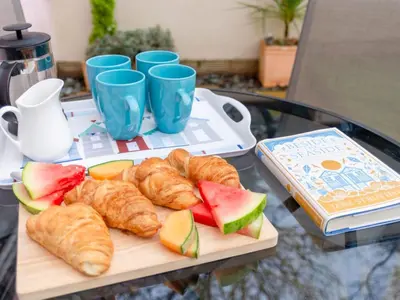 a tray of pastries and croissants on a table at Holiday Home Marshmallow House by Interhome in St Austell