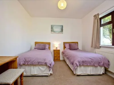 a bedroom with two beds and a window at Holiday Home Francis Bungalow by Interhome in Helston