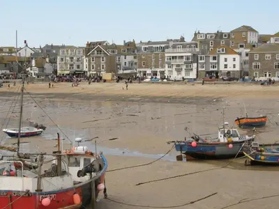 three boats sitting on the sand at the beach at Holiday Home Francis Bungalow by Interhome in Helston