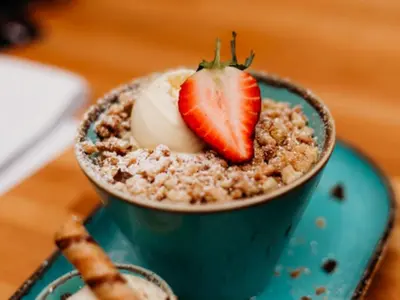 a bowl of oatmeal with a strawberry on top at Chalet Hot Tub Lodge 1 by Interhome in Helston