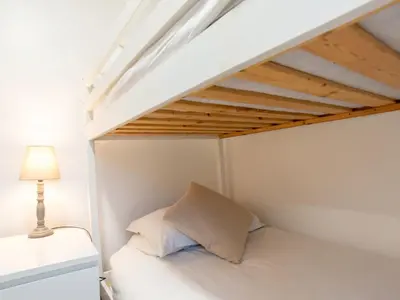 a bedroom with a bed under a loft bed at Chalet Hot Tub Lodge 3 by Interhome in Helston