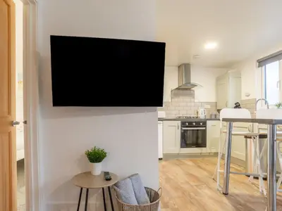 a tv hanging on a wall in a kitchen at Chalet Hot Tub Lodge 3 by Interhome in Helston