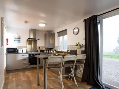 a kitchen with a table and chairs in a room at Chalet Lodge 3 by Interhome in Helston
