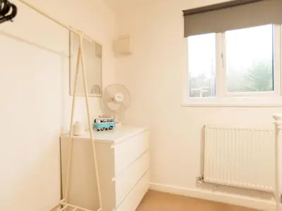 a dressing room with a mirror and a dresser at Chalet Lodge 3 by Interhome in Helston