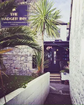 a building with a sign that reads the ledger inn at The Badger Inn in Carbis Bay