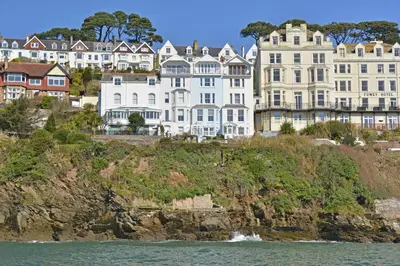 a group of buildings on a cliff next to the water at 1 Bed in Fowey oc-p00802 in Fowey