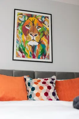 a painting of a tiger on the wall above a bed at 1 Bed in Fowey oc-p00802 in Fowey