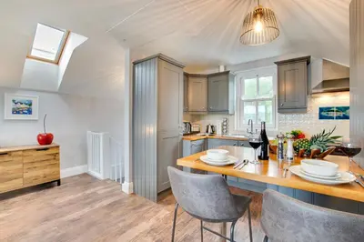 a kitchen with a table and chairs and a counter at 1 Bed in Fowey oc-p00802 in Fowey