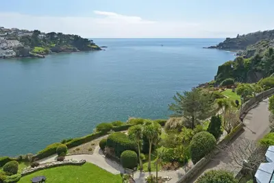 an aerial view of the ocean with palm trees at 1 Bed in Fowey oc-p00802 in Fowey