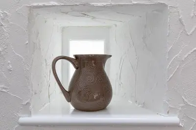 a brown vase sitting on a shelf in a window at Treworgie Barton - Warner in Bude