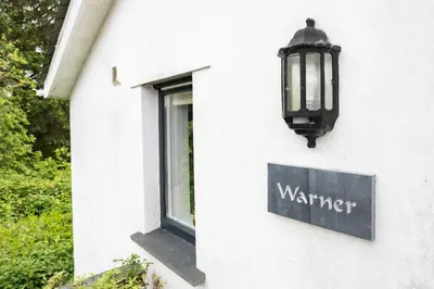 a sign on the side of a building with a window at Treworgie Barton - Warner in Bude