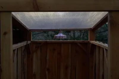 an inside view of a wooden fence with a roof at Trevena Cross Glamping & Camping in Helston