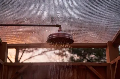 a shower with water coming out of it at Trevena Cross Glamping & Camping in Helston