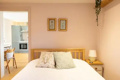 a bedroom with a bed and a table with a lamp at Secluded woodland annex between Mylor and Flushing in Falmouth
