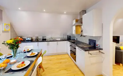 a kitchen and dining room with a table and chairs at St Ives Fir Tree Lodge in St Ives