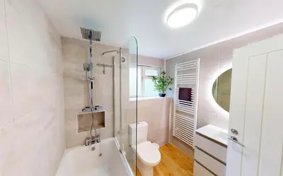 a bathroom with a tub and a toilet and a sink at St Ives Fir Tree Lodge in St Ives