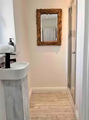 a bathroom with a sink and a mirror on the wall at Wonderful Beach House Just 250m From The Sea in Newquay