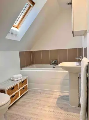 a bathroom with a white tub and a sink at Wonderful Beach House Just 250m From The Sea in Newquay