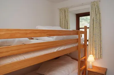 two bunk beds in a room with a window at Goodrevy Barn in Launceston